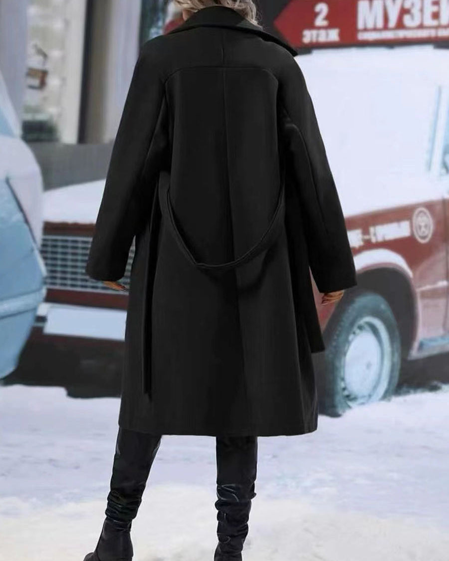 Woman in long belted double-breasted coat