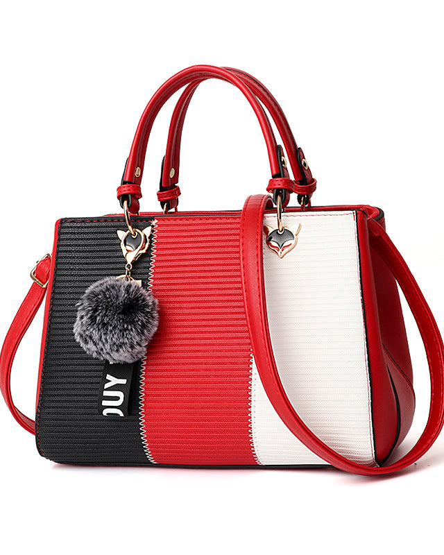 Colorblock handbag with pom-pom charm