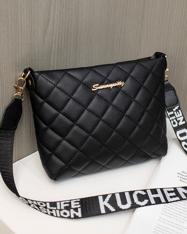 Black quilted crossbody bag with wide strap