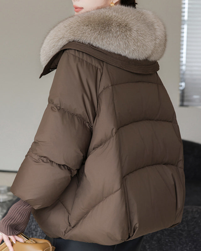 Woman in short puffer jacket with fur collar