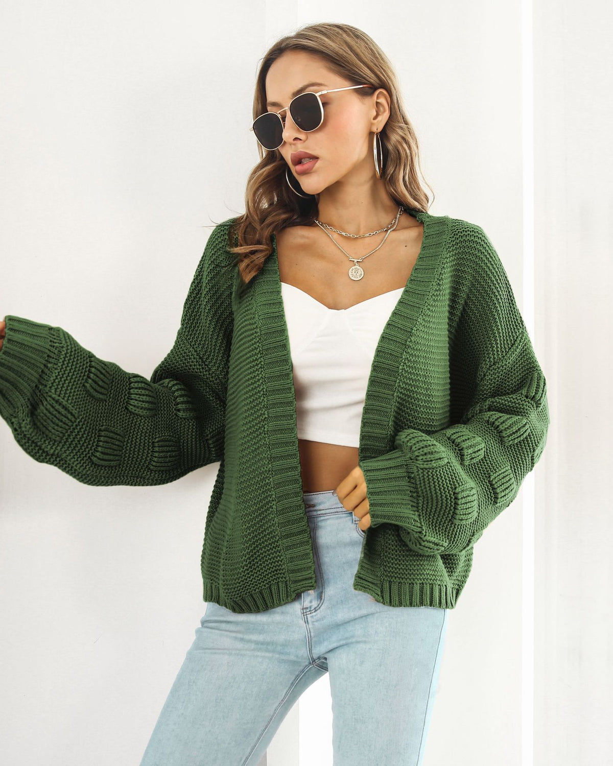 Woman in chunky cable knit puff sleeve cardigan