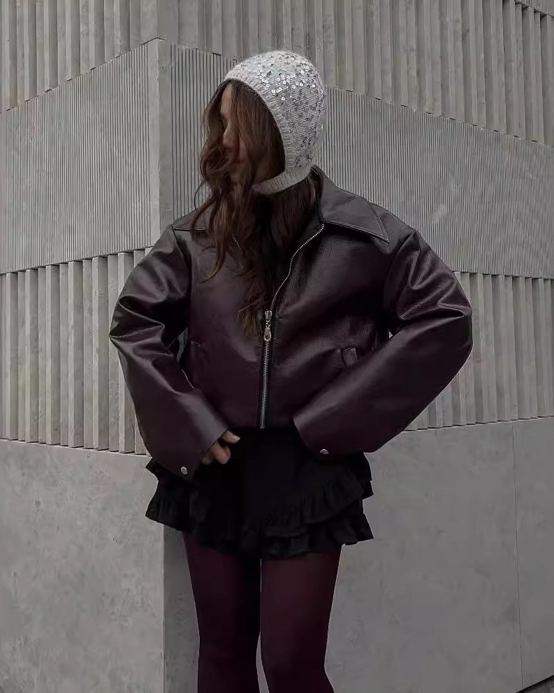 Woman in a cropped burgundy leather jacket
