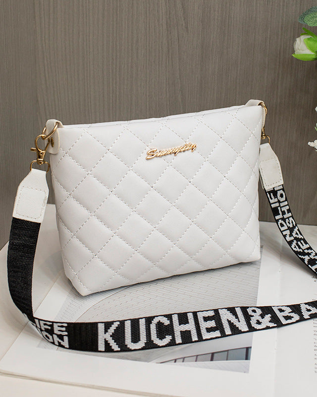 Black quilted crossbody bag with wide strap