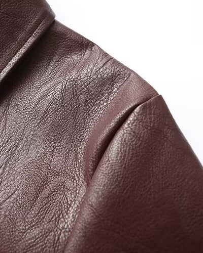 Woman in a cropped burgundy leather jacket
