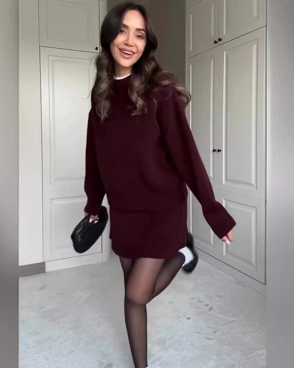 Woman in matching knit sweater and mini skirt set