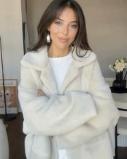 Woman in a short off-white teddy jacket