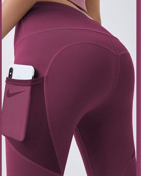 Woman wearing black high-waist leggings with phone pocket