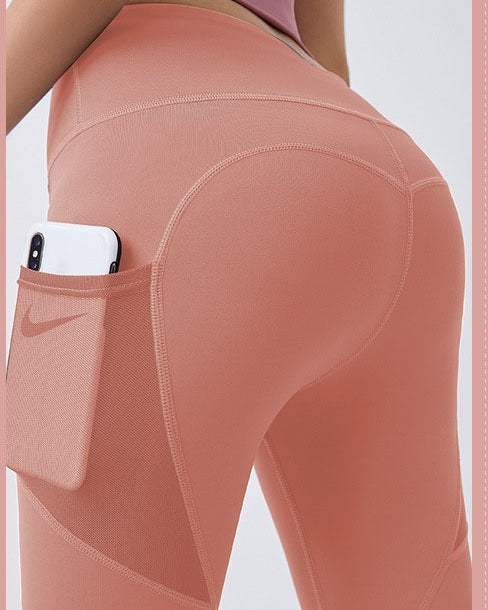 Woman wearing black high-waist leggings with phone pocket