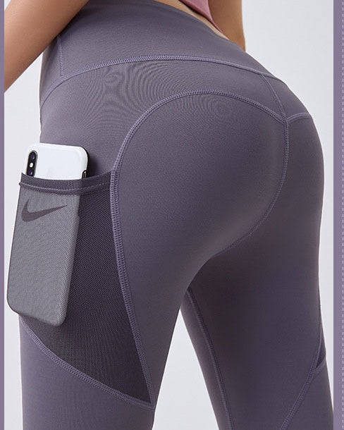 Woman wearing black high-waist leggings with phone pocket
