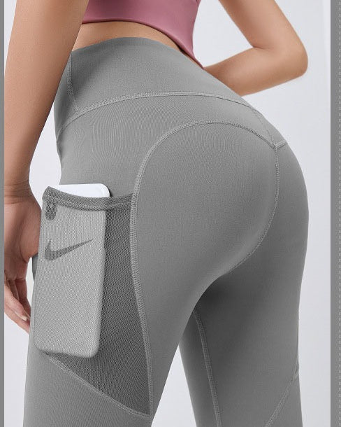 Woman wearing black high-waist leggings with phone pocket