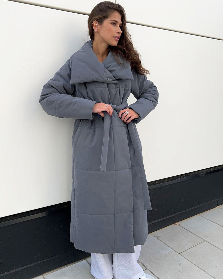 Woman in a long quilted belted coat