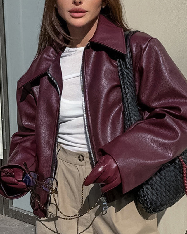 Woman in a cropped burgundy leather jacket