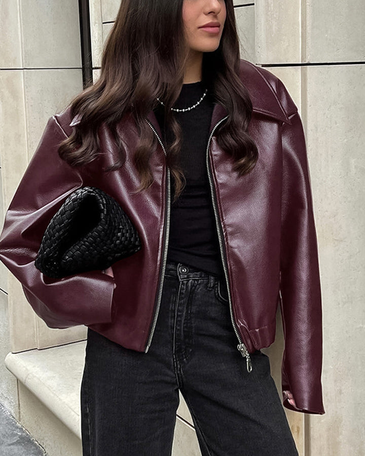 Woman in a cropped burgundy leather jacket