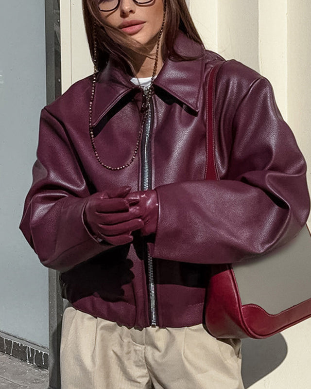 Woman in a cropped burgundy leather jacket