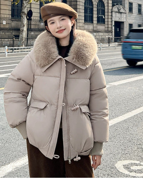 Woman in short puffer jacket with fur collar