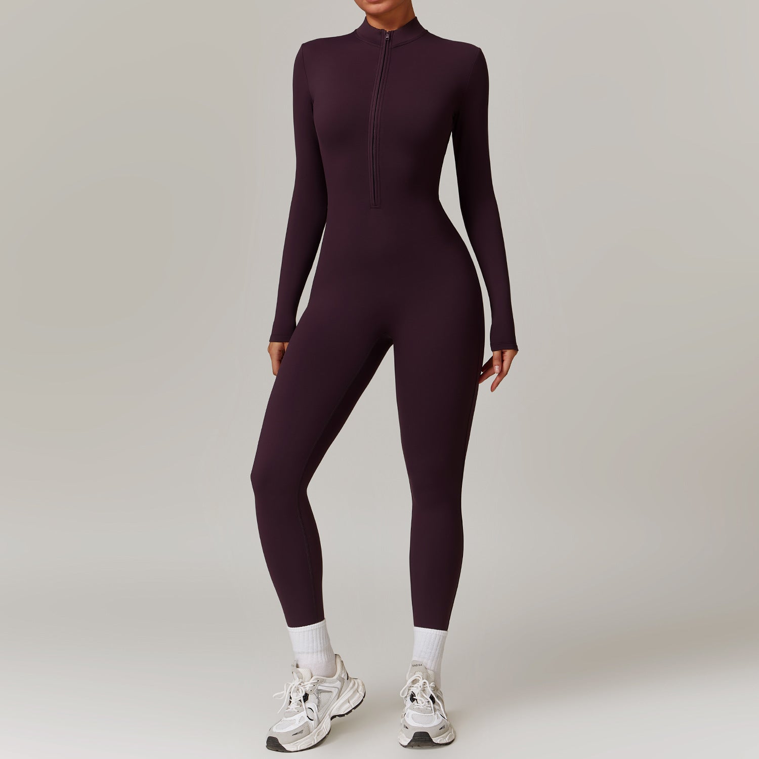 Woman in a zip-front yoga jumpsuit