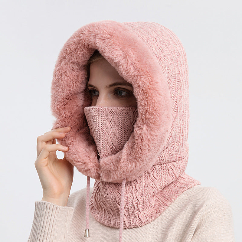 Woman wearing knit hood with faux fur trim