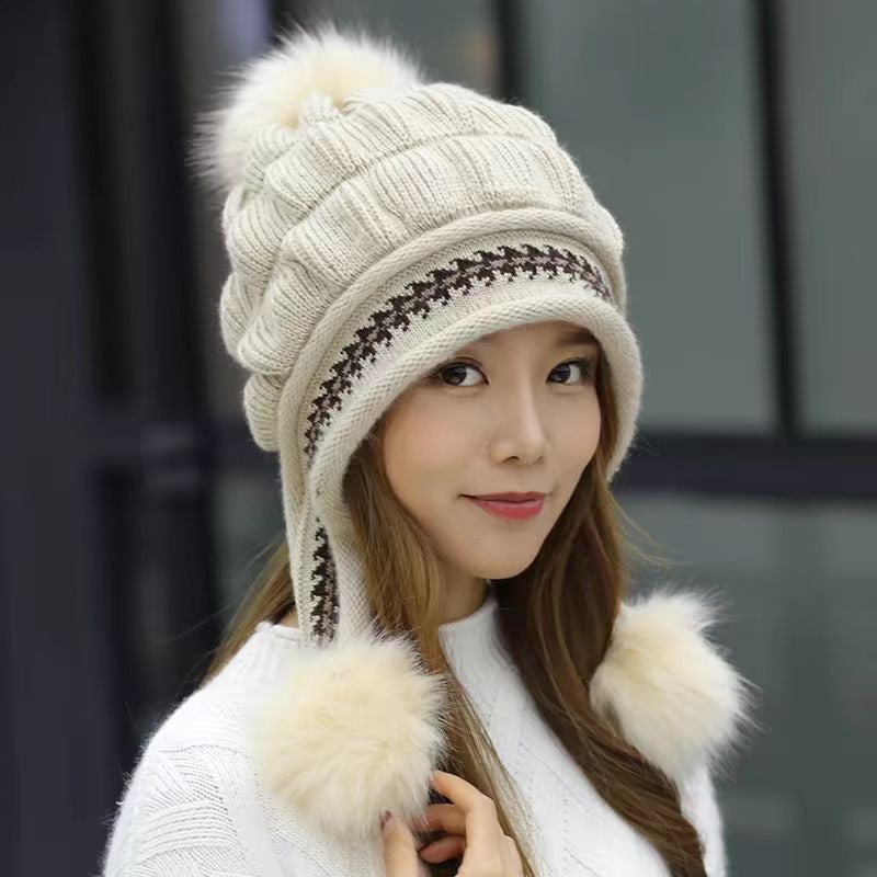 Woman in an ear flap beanie with pompom