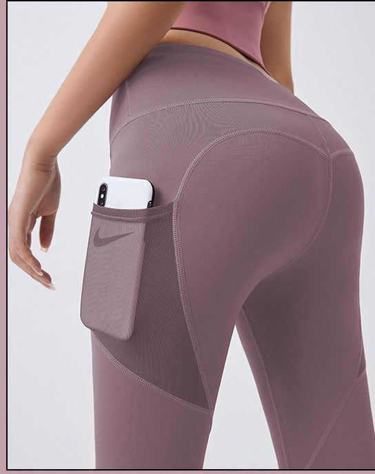 Woman wearing black high-waist leggings with phone pocket