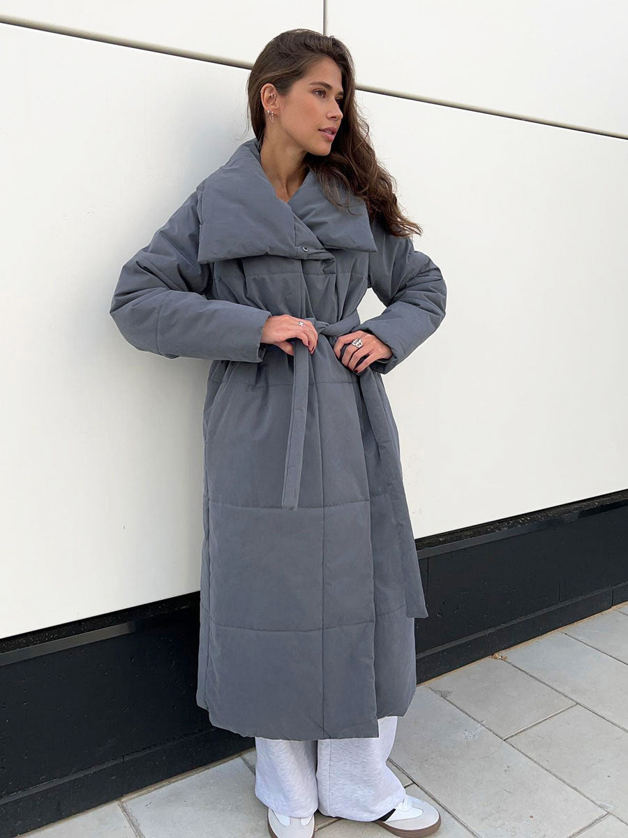 Woman in a long quilted belted coat